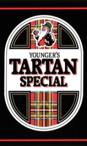 The pic is a closeup of the design of the classic Younger's Tartan Special can, a black beercan with a tall white lozenge shape. In the white lozenge, there are tall panels of red tartan, one of which features the white-bearded figure of Mr Younger on top of it.