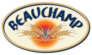 The Beauchamp bread logo looks like an elliptical plaque. Inside the gold edge, there is a cream background with BEAUCHAMP in navy blue type on a curve at the top. Below, four ears of wheat are shown in front of a orange-red-blue circular glow.
