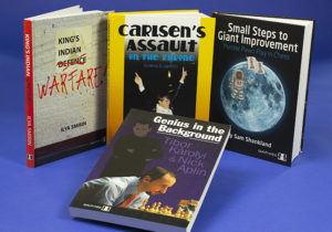 Four bookcover designs – from left to right, a poster defaced on a white brick wall, then a book with a photo of World Chess Champion Magnus Carlsen jumping into a swimming pool on winning the 2013 tournament, then a cartoon pawn in a spacesuit walking on the moon; lastly, in front, “Genius in the Background”, shows a chess player concentrating on his next move whilst a shadowy figure – his coach – watches from the background. These are all chess bookcovers. (Book cover, book-cover.)