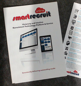 Photo shows the front cover of an A4-plus size presentation folder, with a full-colour photo showing an iMac and an iPad